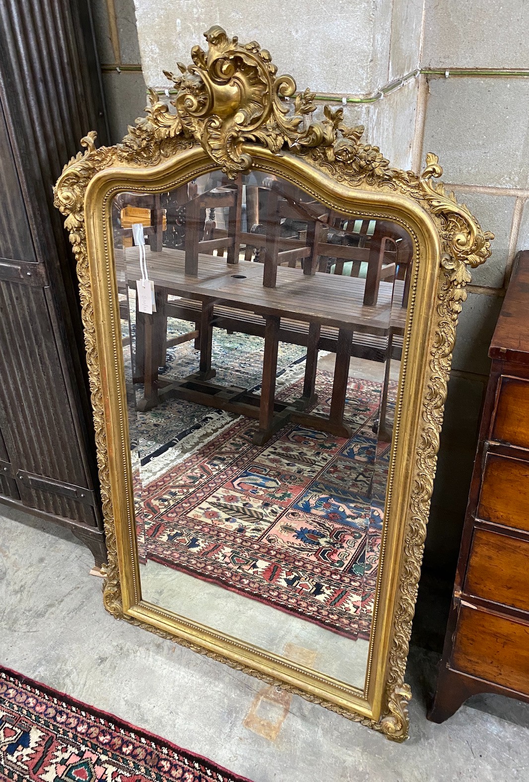 A 19th century French giltwood and composition wall mirror with floral shell pediment, width 90cm, height 152cm